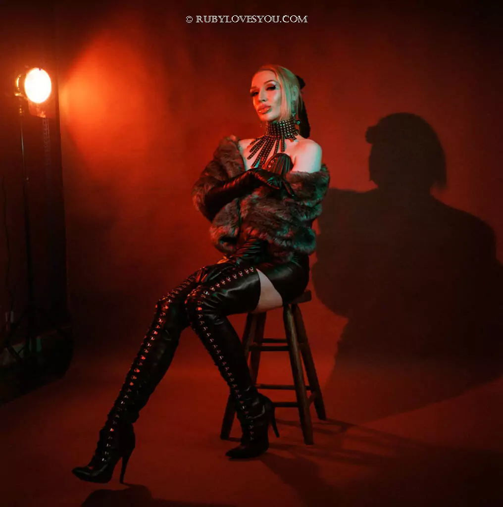 Seattle Dominatrix Ruby Enraylls is dressed in black latex with her latex slave in her Seattle BDSM Dungeon where she takes requests for Femdom and mistress sessions